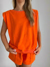 orange sleeveless women's sweater top with padded shoulders